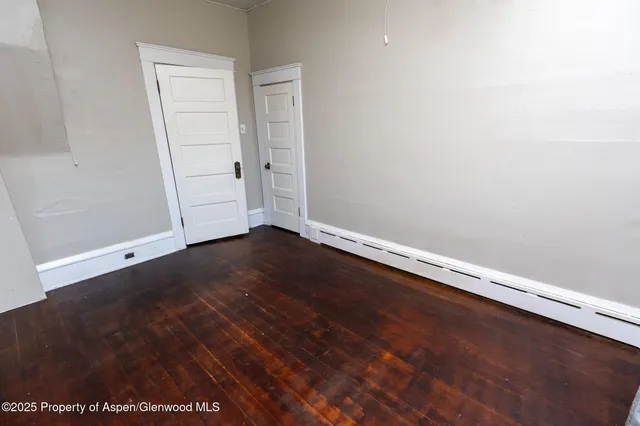 an empty room with wooden floor