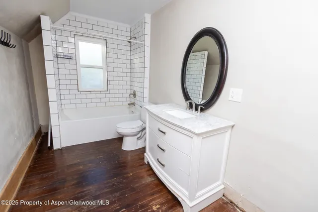 a bathroom with a toilet a sink and a mirror
