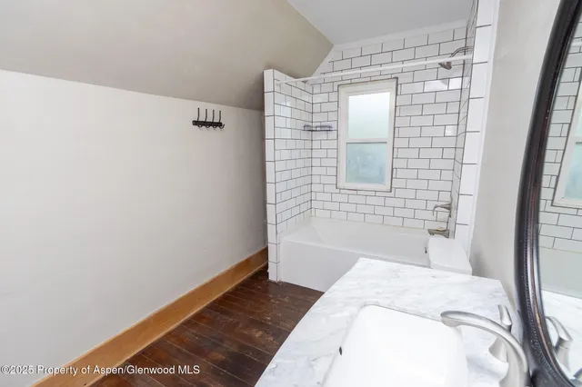 a bathroom with a bathtub and shower