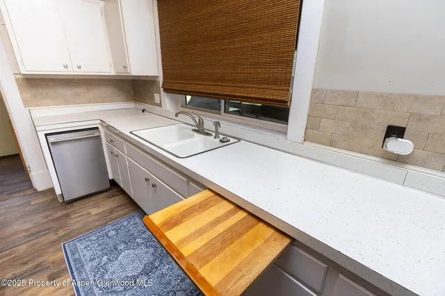 a kitchen with sink and cabinets