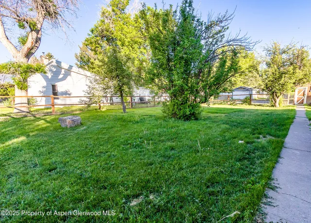 a view of yard with swimming pool and green space