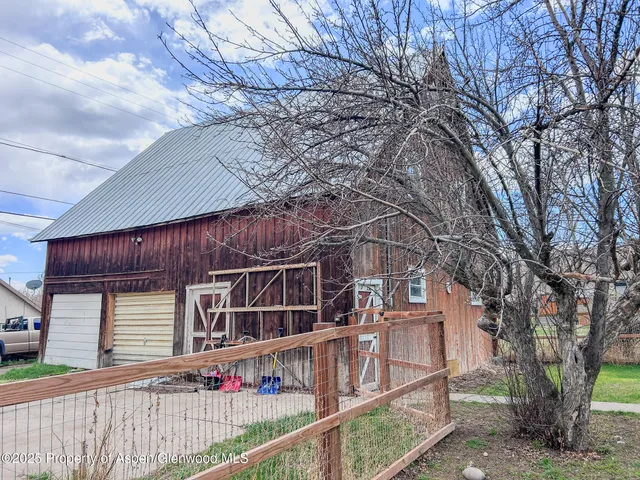 a wooden house with large trees