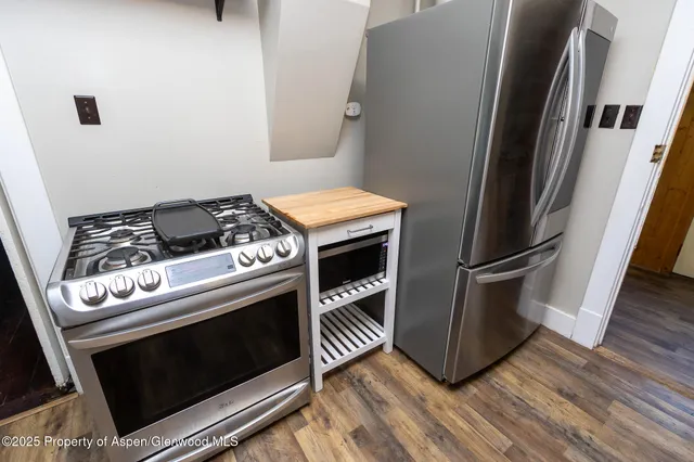 a stove top oven sitting inside of a kitchen