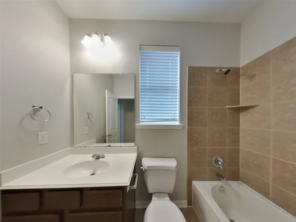 a bathroom with a sink shower and a toilet