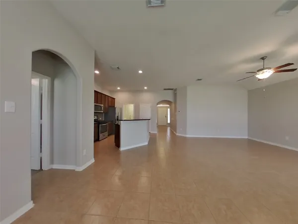 a view of a kitchen with a sink and a refrigerator