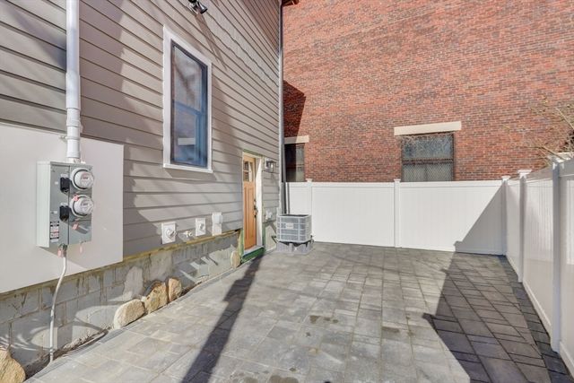 a view of a brick house with many windows
