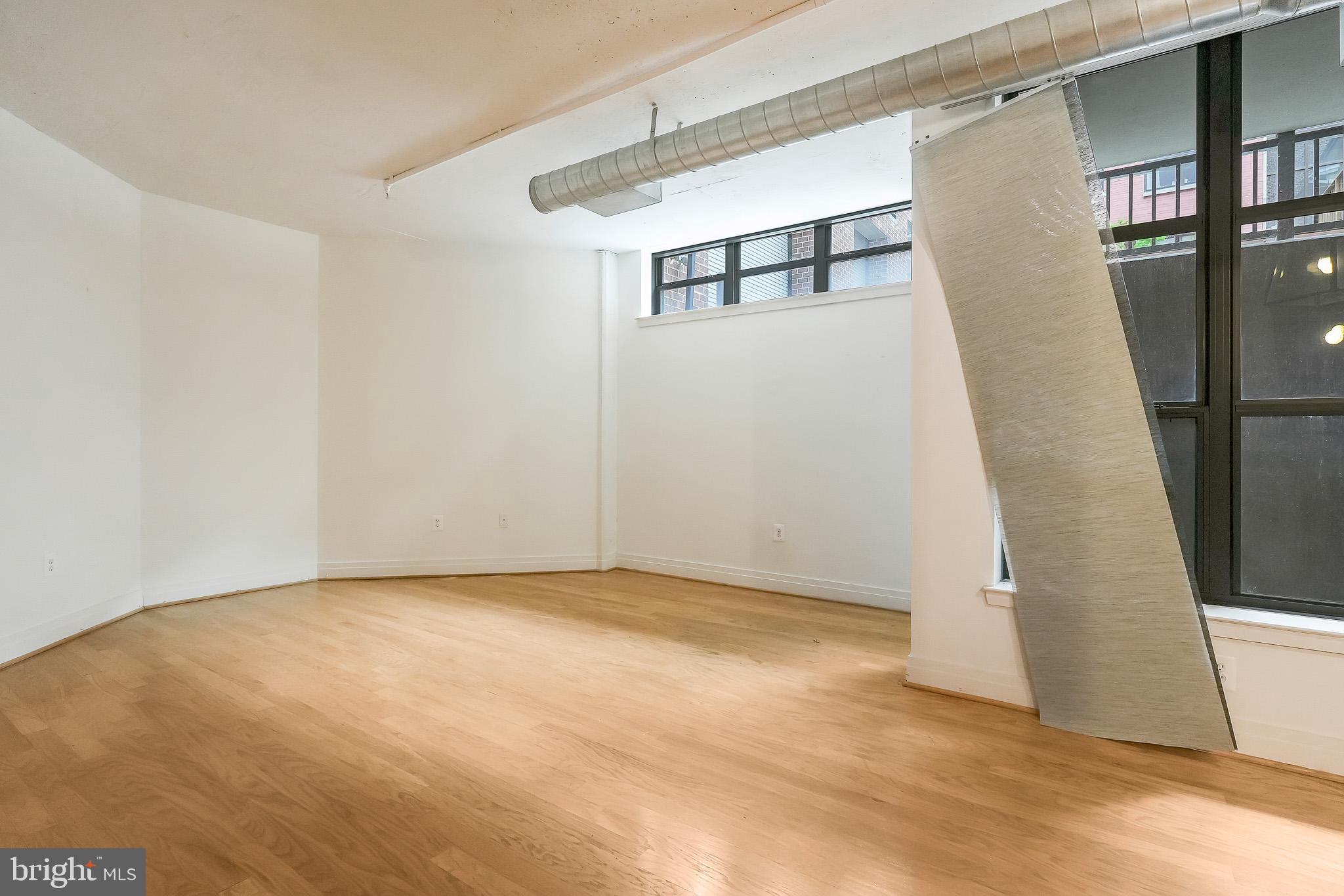 2020 12th Street Northwest, Unit T05 Washington, DC 20009 - Photo 11 of 38 a view of an empty room with wooden floor and stairs