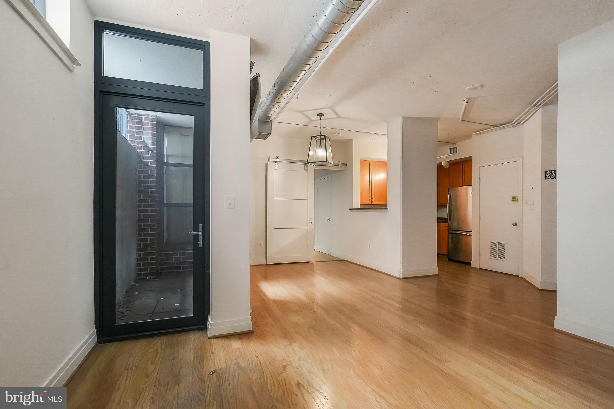 2020 12th Street Northwest, Unit T05 Washington, DC 20009 - Photo 12 of 38 a view of a hallway with wooden floor and a bathroom