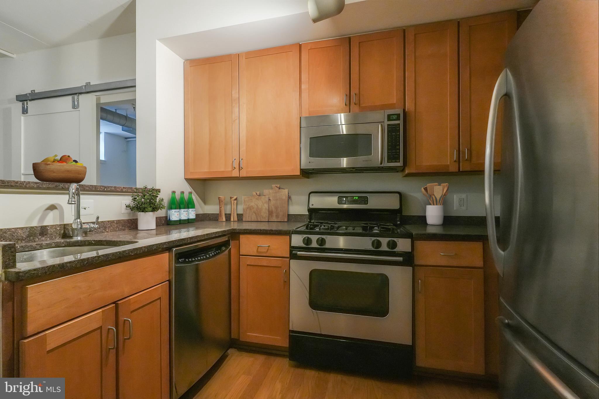 2020 12th Street Northwest, Unit T05 Washington, DC 20009 - Photo 13 of 38 a kitchen with stainless steel appliances granite countertop a stove a sink and a refrigerator