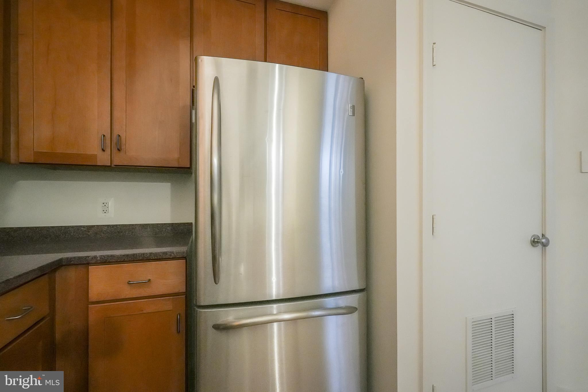 2020 12th Street Northwest, Unit T05 Washington, DC 20009 - Photo 31 of 38 a white refrigerator freezer sitting in a kitchen