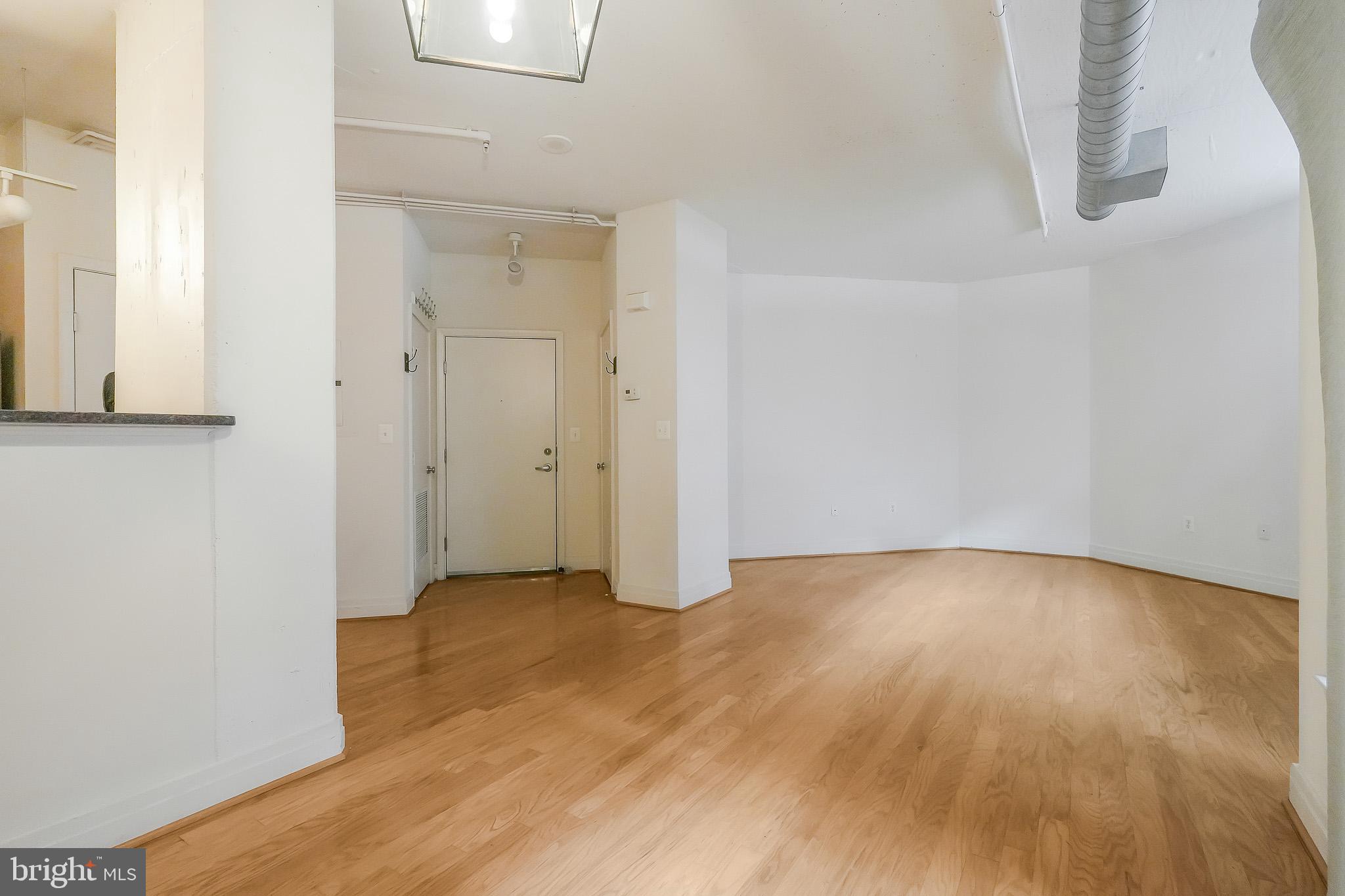 2020 12th Street Northwest, Unit T05 Washington, DC 20009 - Photo 37 of 38 a view of an empty room with wooden floor
