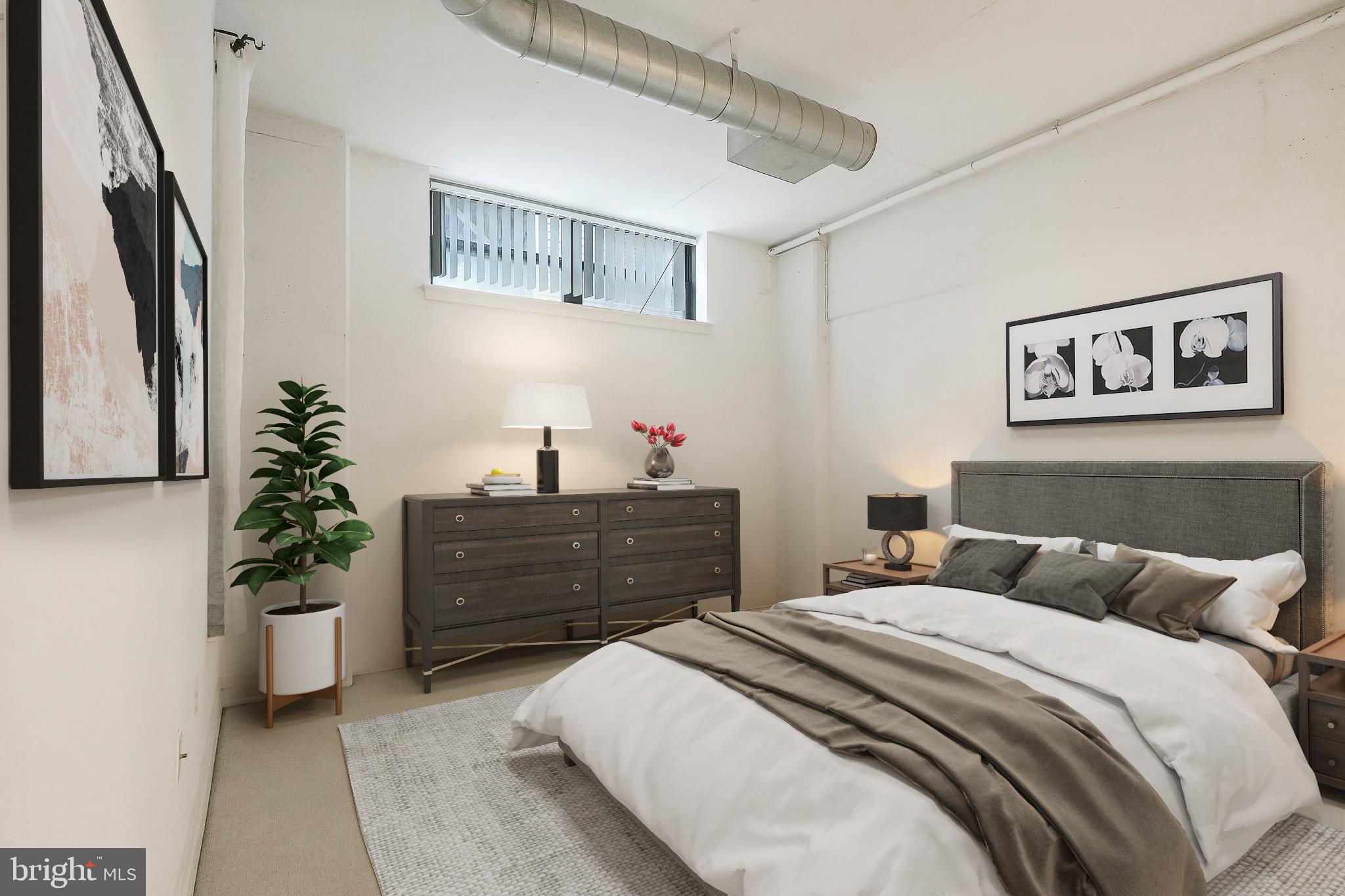 2020 12th Street Northwest, Unit T05 Washington, DC 20009 - Photo 9 of 38 a bedroom with a bed and a potted plant