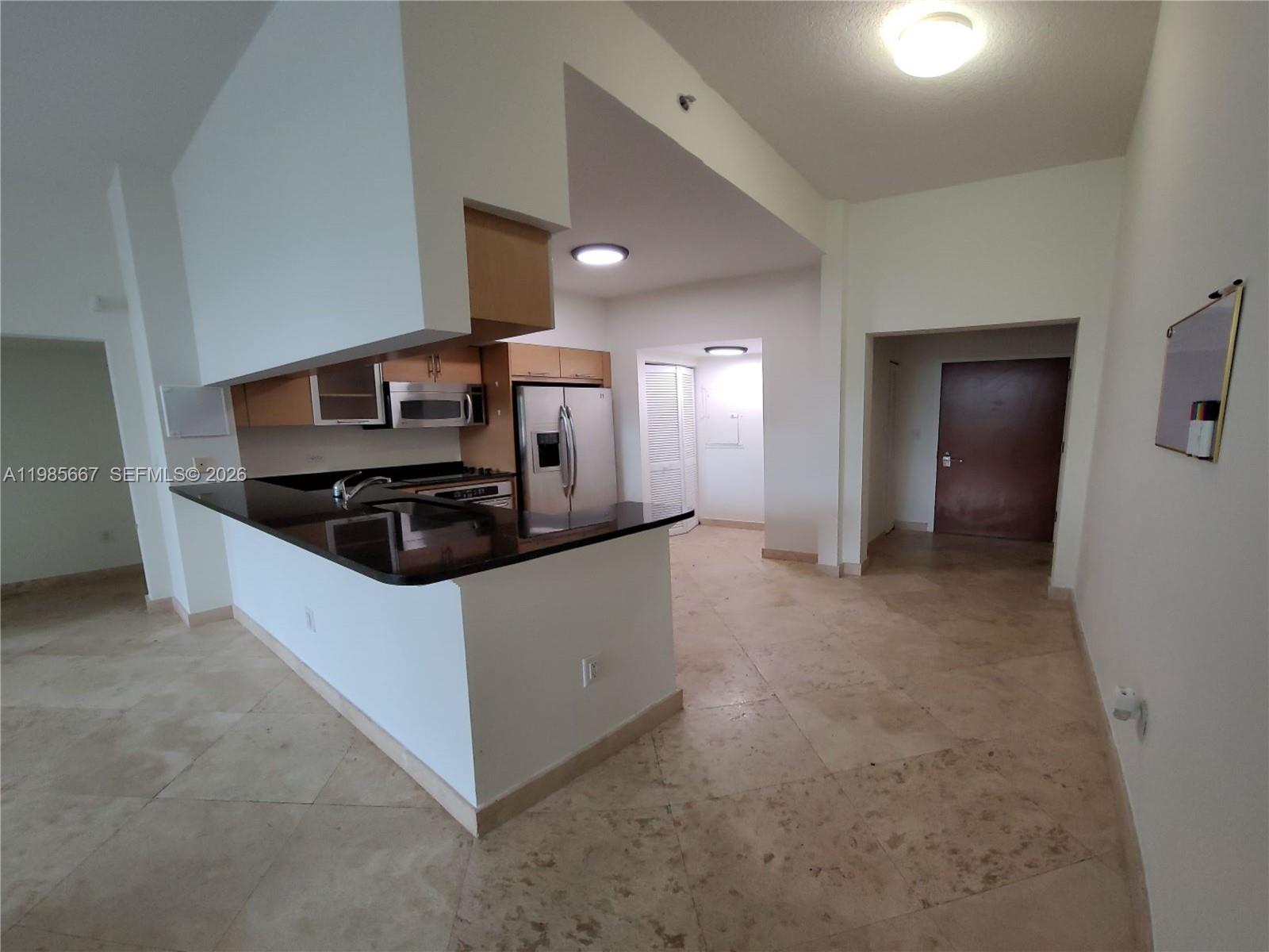 31 Southeast 5th Street, Unit 1110 Miami, FL 33131 - Photo 9 of 61 a kitchen with stainless steel appliances a refrigerator and stove