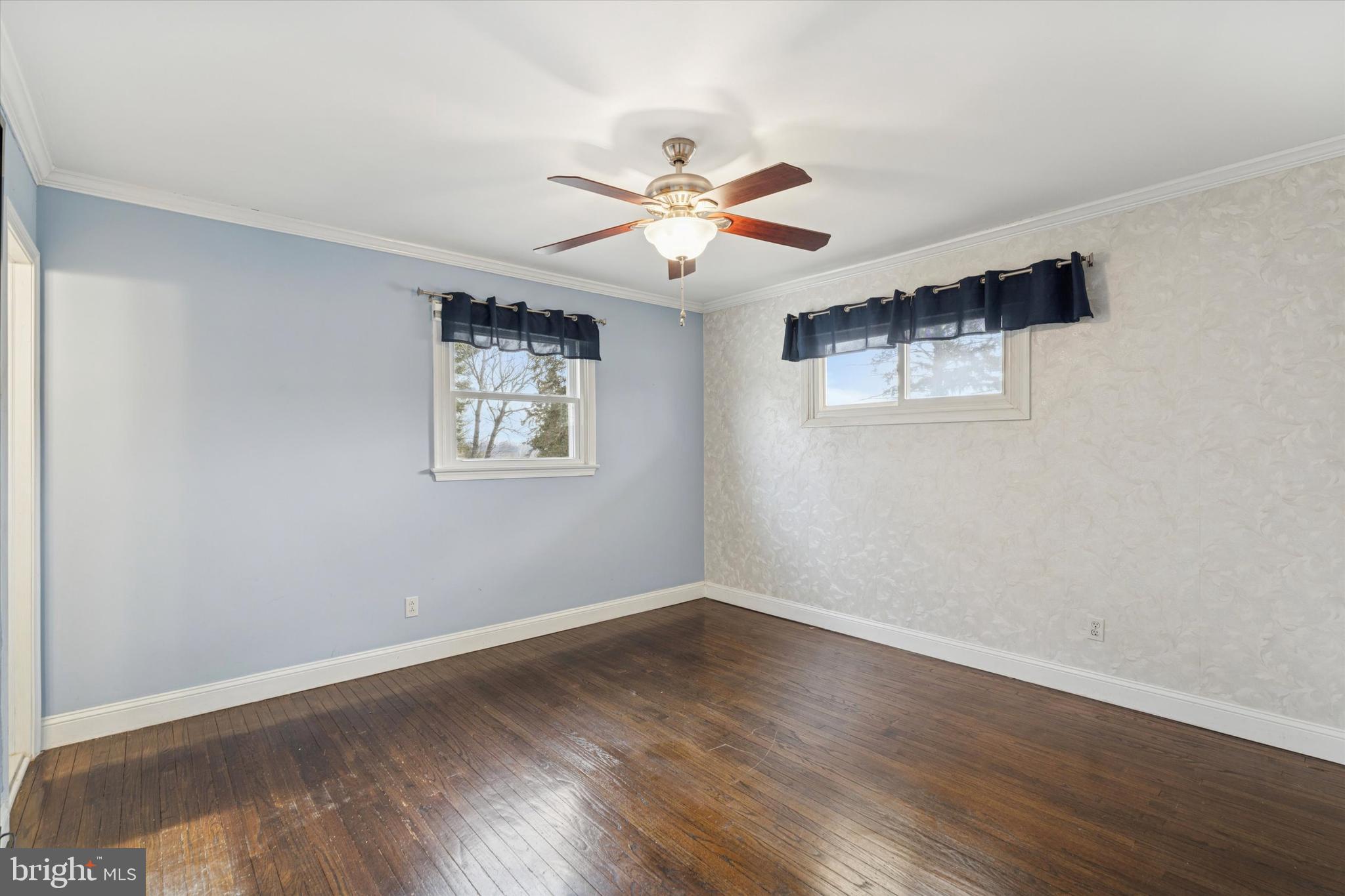 415 Milford Road Broomall, PA 19008 - Photo 15 of 29 a view of an empty room with window and wooden floor