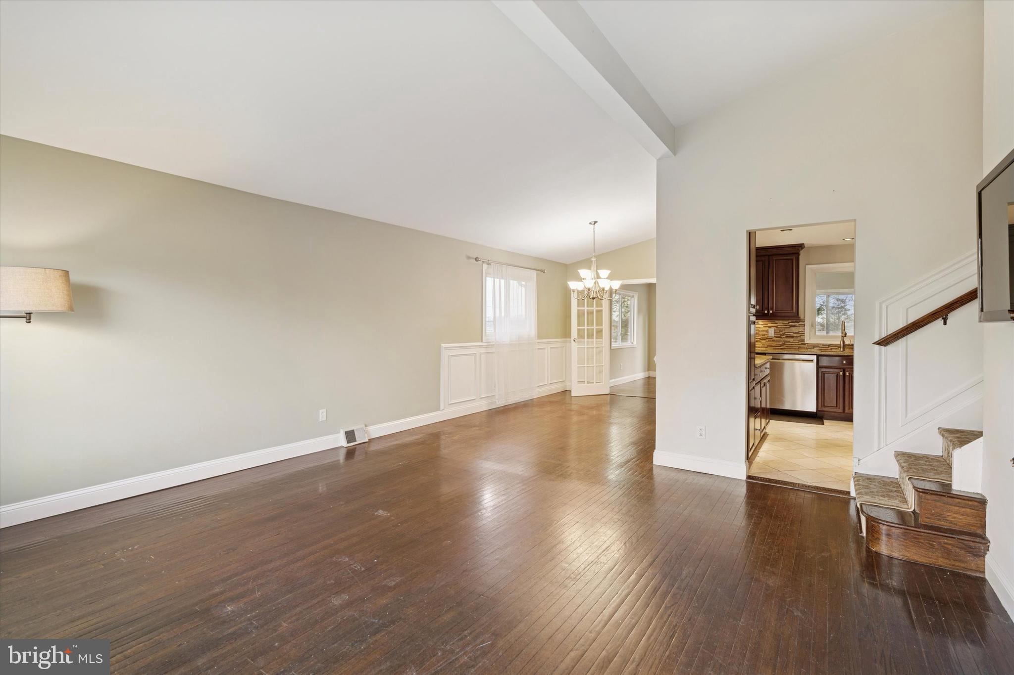 415 Milford Road Broomall, PA 19008 - Photo 3 of 29 a view of an empty room with wooden floor and a kitchen