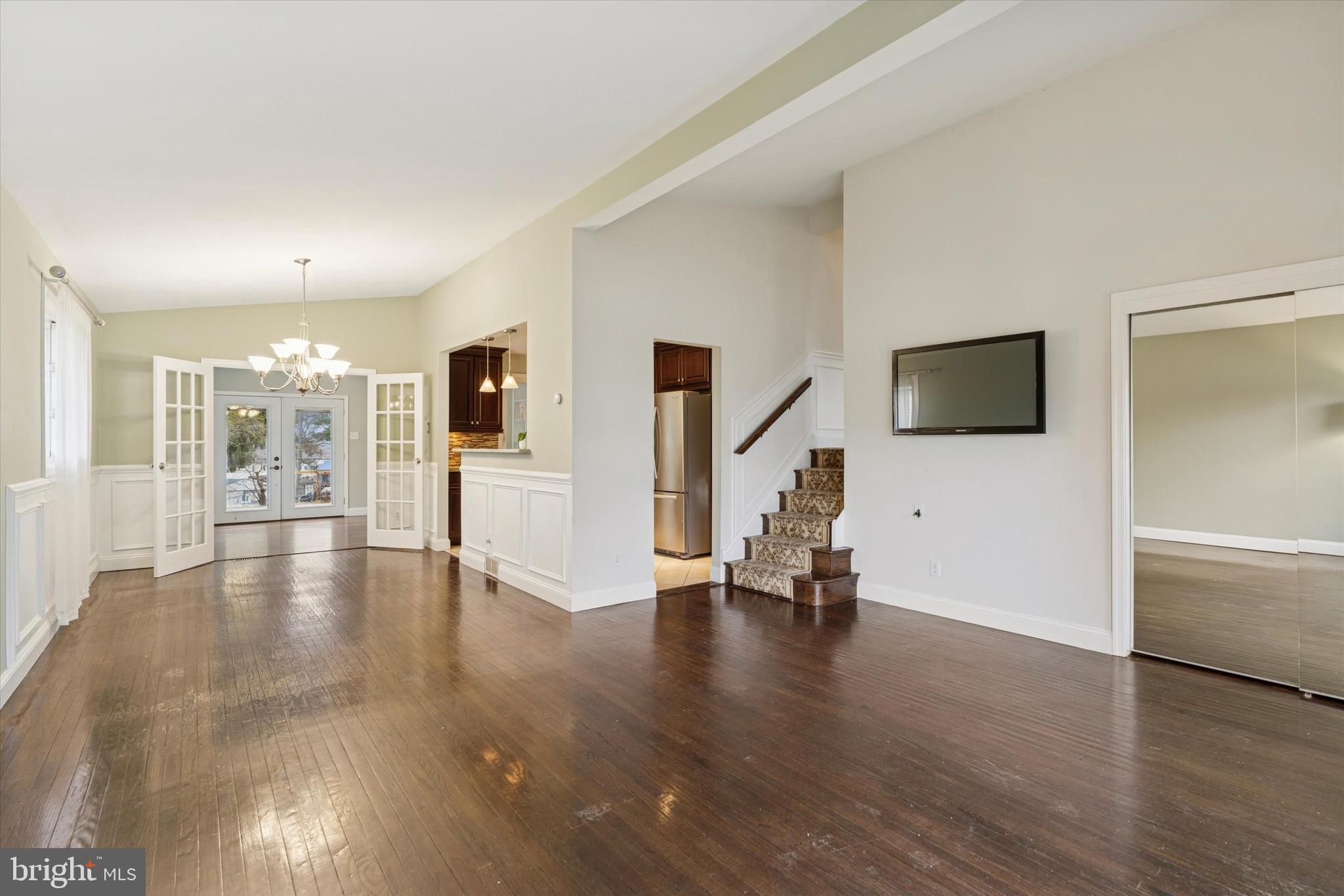 415 Milford Road Broomall, PA 19008 - Photo 4 of 29 a view of an empty room with wooden floor and a view of a living room