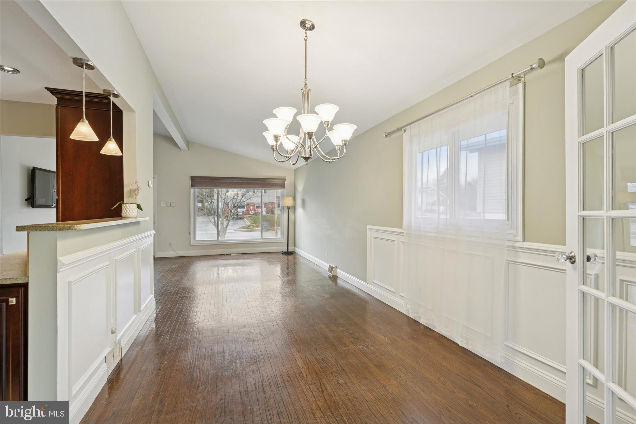 415 Milford Road Broomall, PA 19008 - Photo 7 of 29 a hallway with wooden floor chandelier and entryway