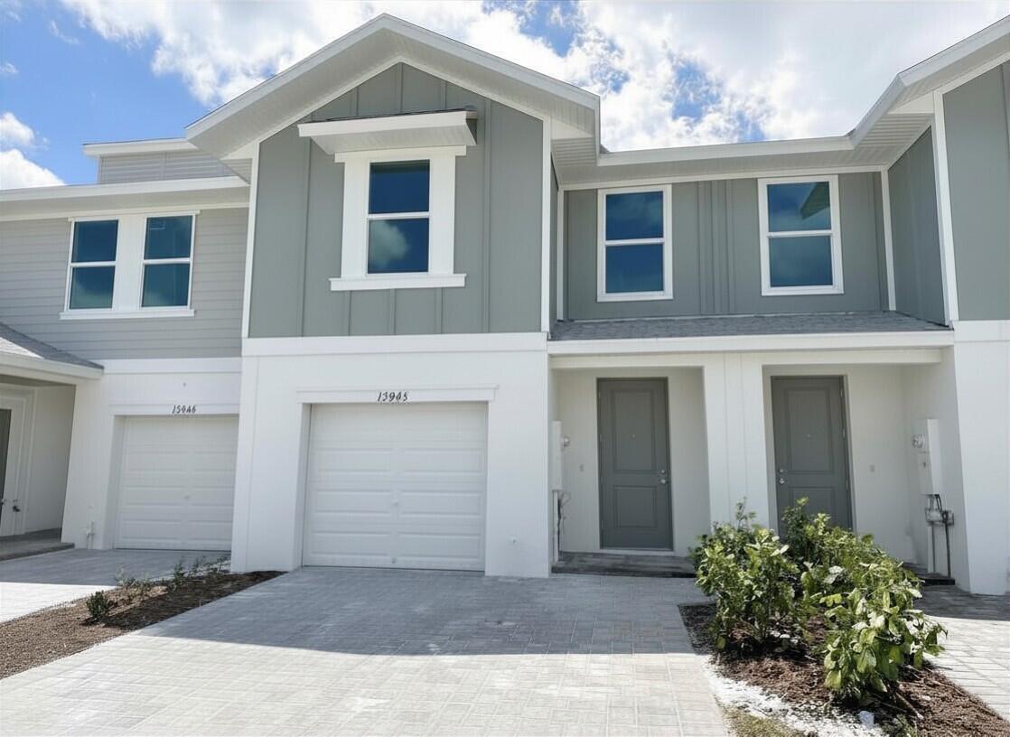 12945 Southwest Forli Way Port St. Lucie, FL 34987 - Photo 2 of 13 a front view of a house with a yard and garage