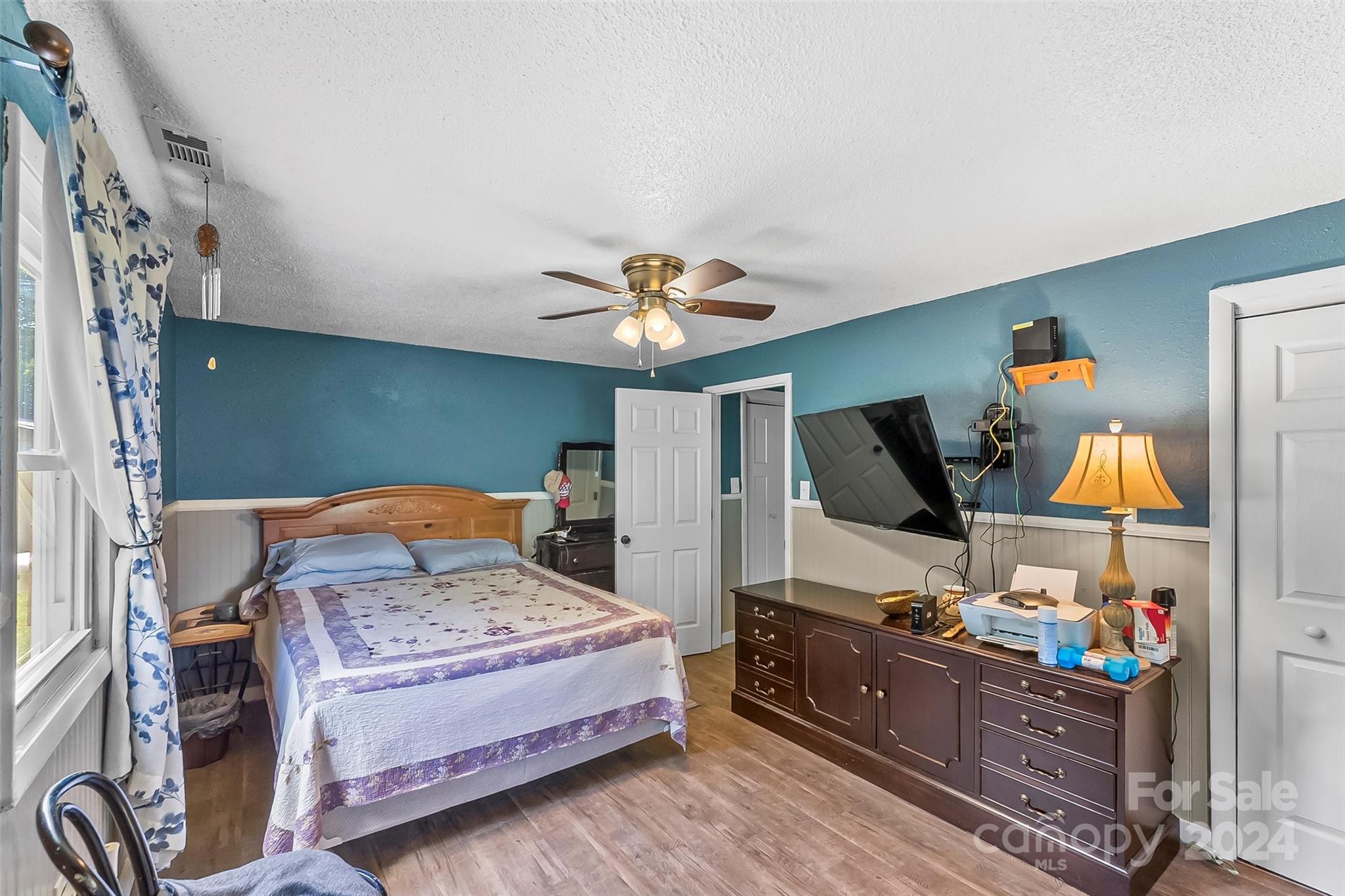 1529 Tatertown Loop Nebo, NC 28761 - Photo 14 of 38 a bedroom with a bed and a flat screen tv