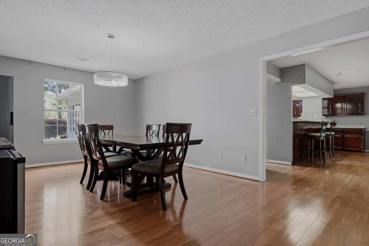 2811 Lullwater Road Tifton, GA 31794 - Photo 18 of 64 a view of a dining room with furniture and wooden floor