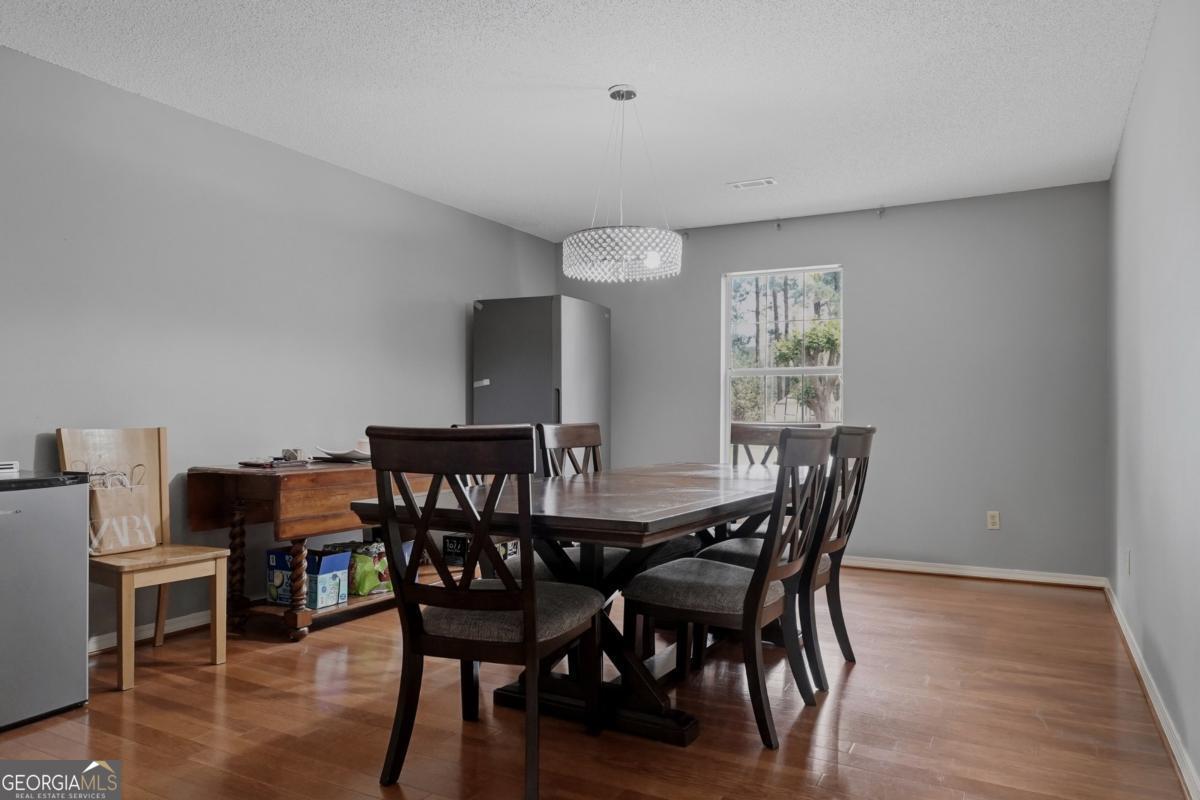 2811 Lullwater Road Tifton, GA 31794 - Photo 19 of 64 a view of a dining room with furniture and wooden floor