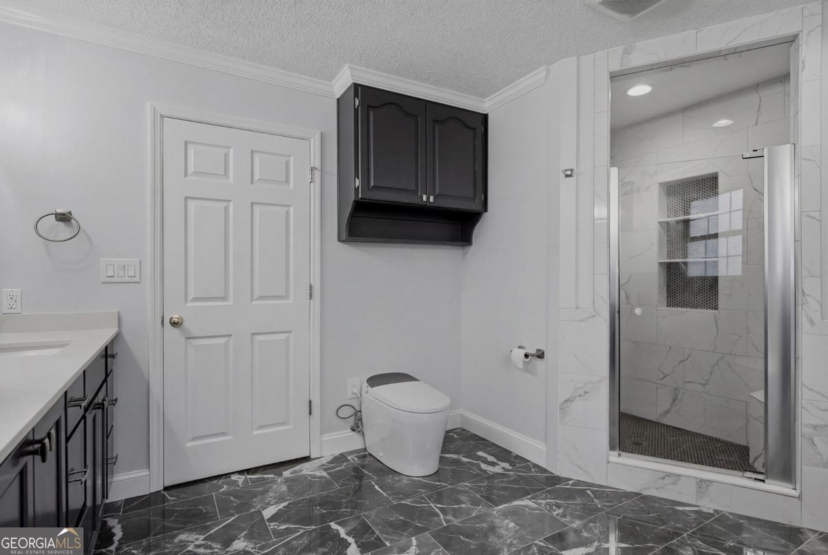 2811 Lullwater Road Tifton, GA 31794 - Photo 30 of 64 a bathroom with a toilet and a shower