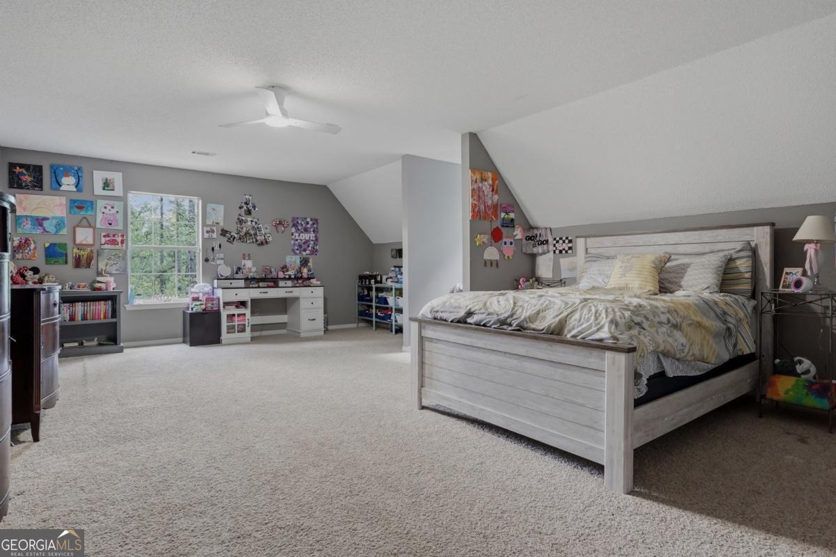 2811 Lullwater Road Tifton, GA 31794 - Photo 37 of 64 a bedroom with a bed couch and a large window