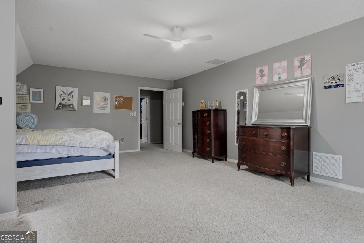 2811 Lullwater Road Tifton, GA 31794 - Photo 38 of 64 a spacious bedroom with a bed and a desk