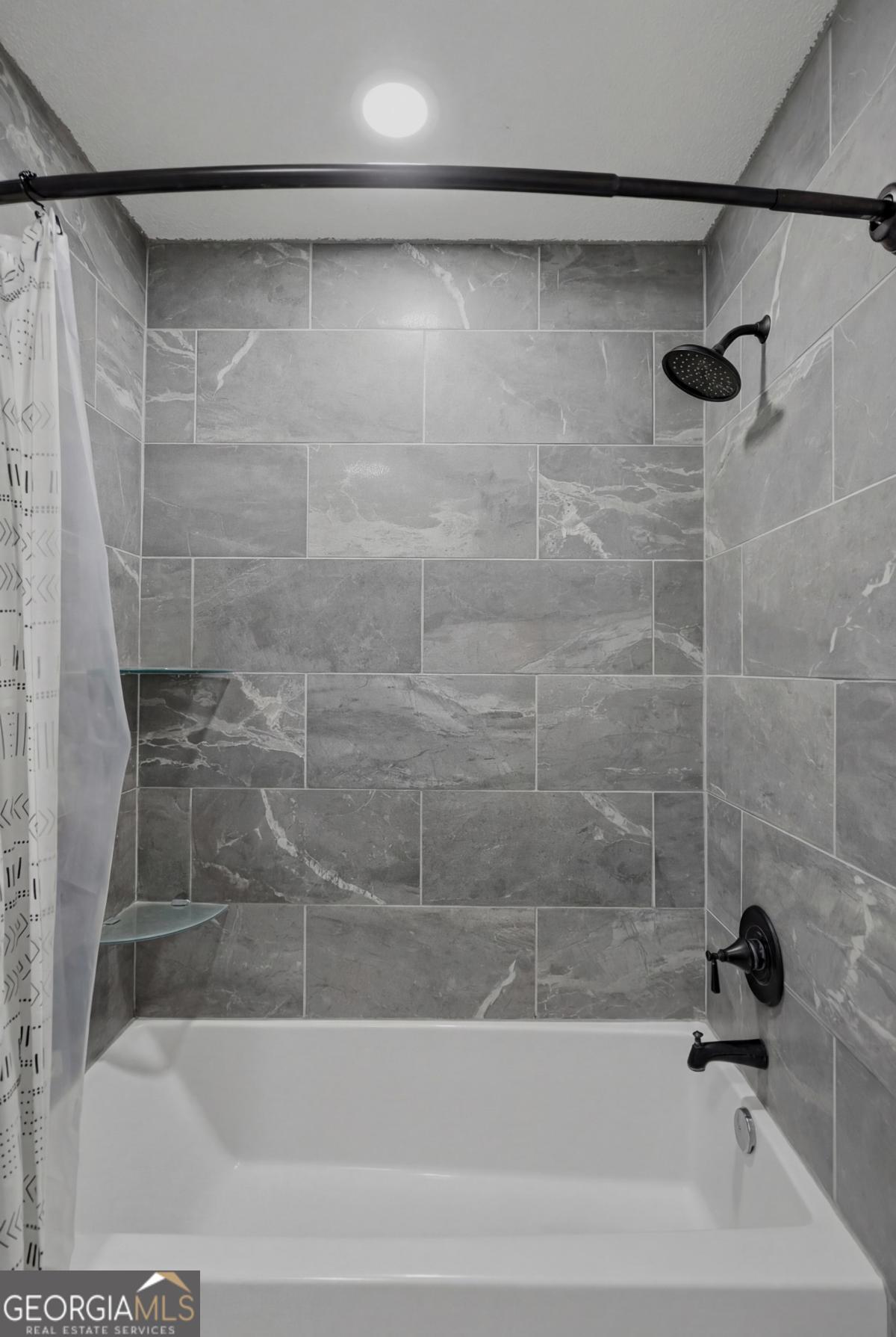 2811 Lullwater Road Tifton, GA 31794 - Photo 43 of 64 a bathroom with a bathtub and a shower