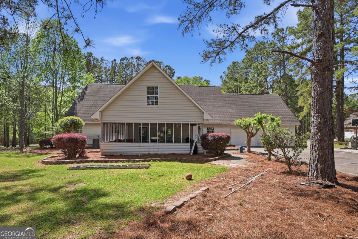 2811 Lullwater Road Tifton, GA 31794 - Photo 50 of 64 a view of a house with a yard patio and a slide