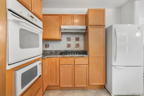 a kitchen with a refrigerator and a stove