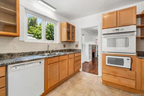 a kitchen with stainless steel appliances granite countertop cabinets and window