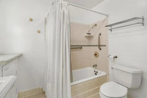 a bathroom with a toilet and a bathtub