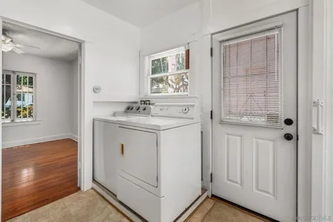 a utility room with cabinets washer and dryer