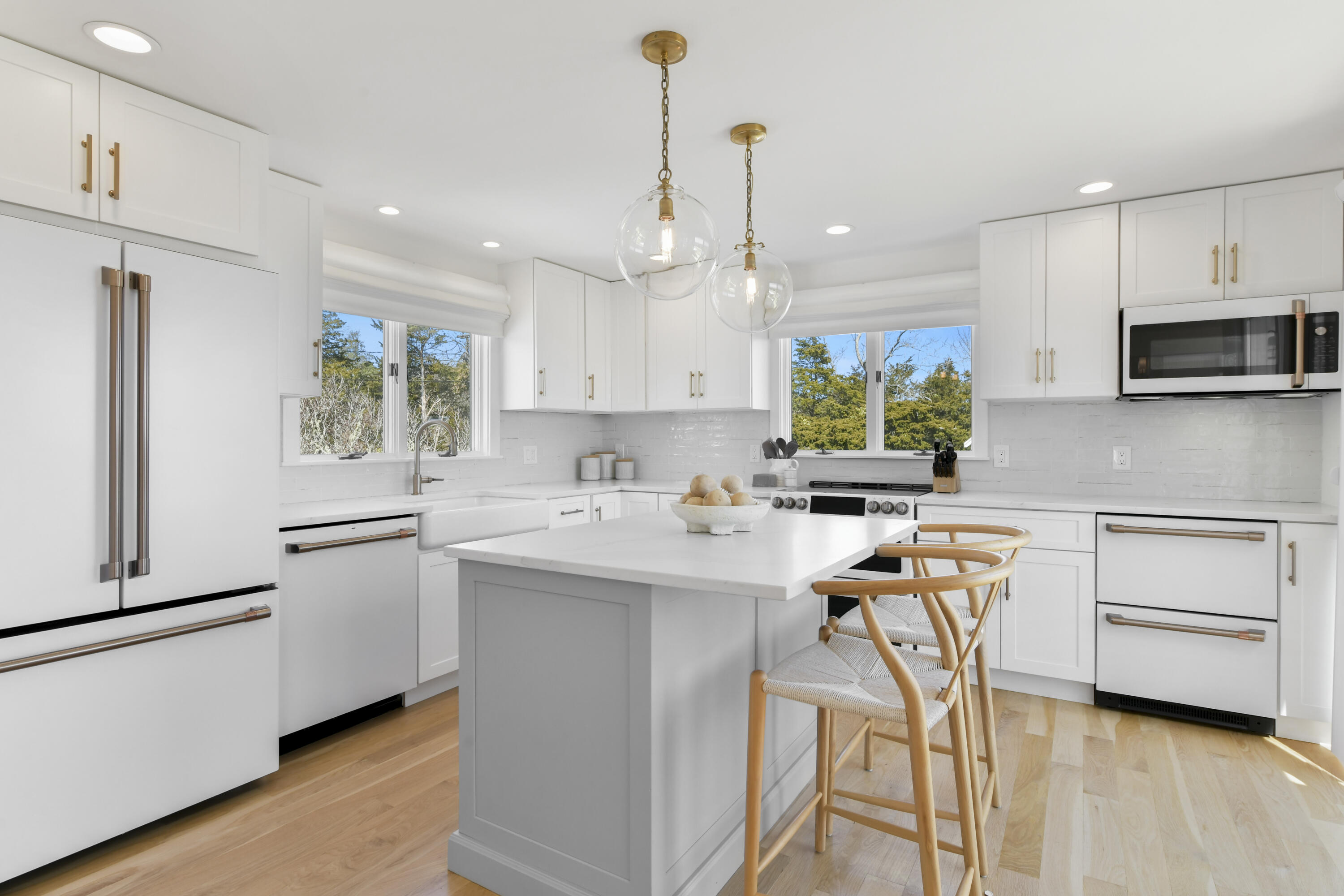 3 Harbor Road Orleans, MA 02653 - Photo 9 of 36 a kitchen with a sink stainless steel appliances and white cabinets