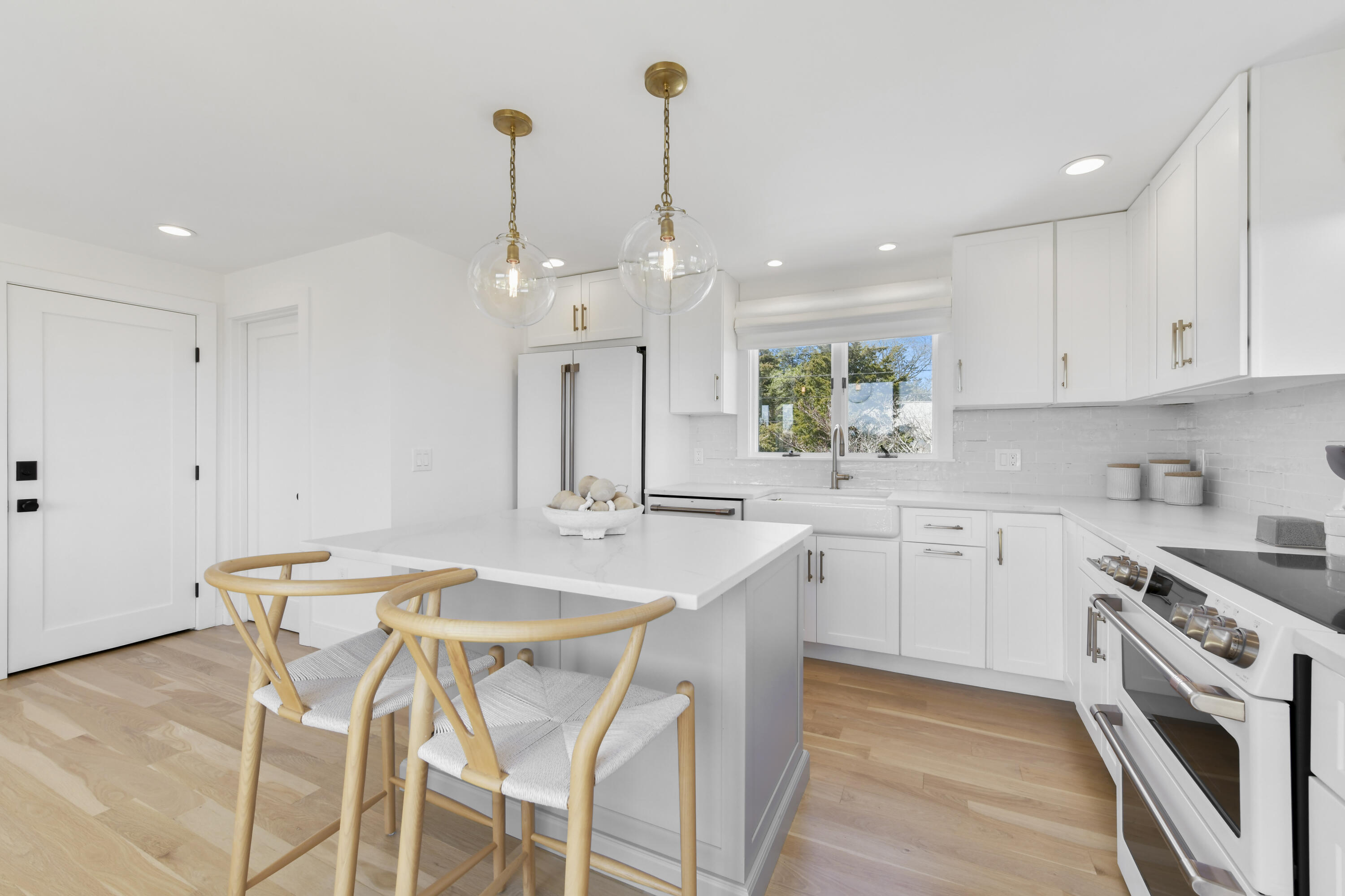 3 Harbor Road Orleans, MA 02653 - Photo 10 of 36 a kitchen with stainless steel appliances kitchen island granite countertop a sink a stove a dining table and chairs