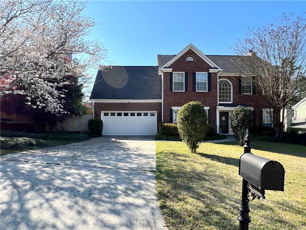 5415 Taylor Road Alpharetta, GA 30022 - Photo 1 of 29 a front view of a house with garden