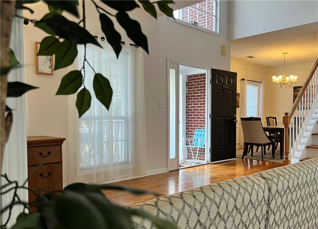 5415 Taylor Road Alpharetta, GA 30022 - Photo 12 of 29 a bedroom with a bed and a chandelier