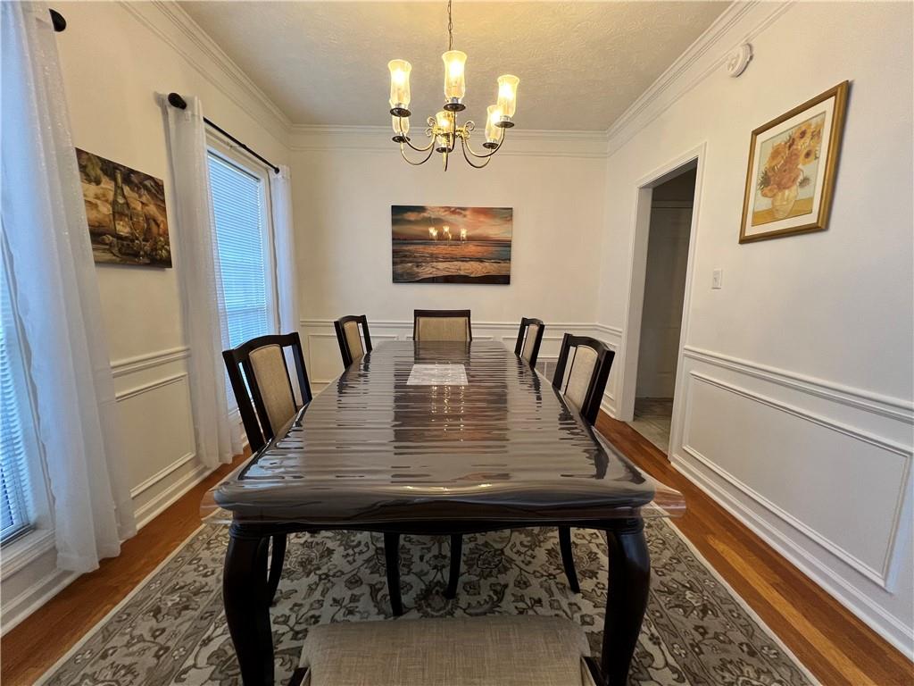 5415 Taylor Road Alpharetta, GA 30022 - Photo 13 of 29 a view of a dining room with furniture window and wooden floor