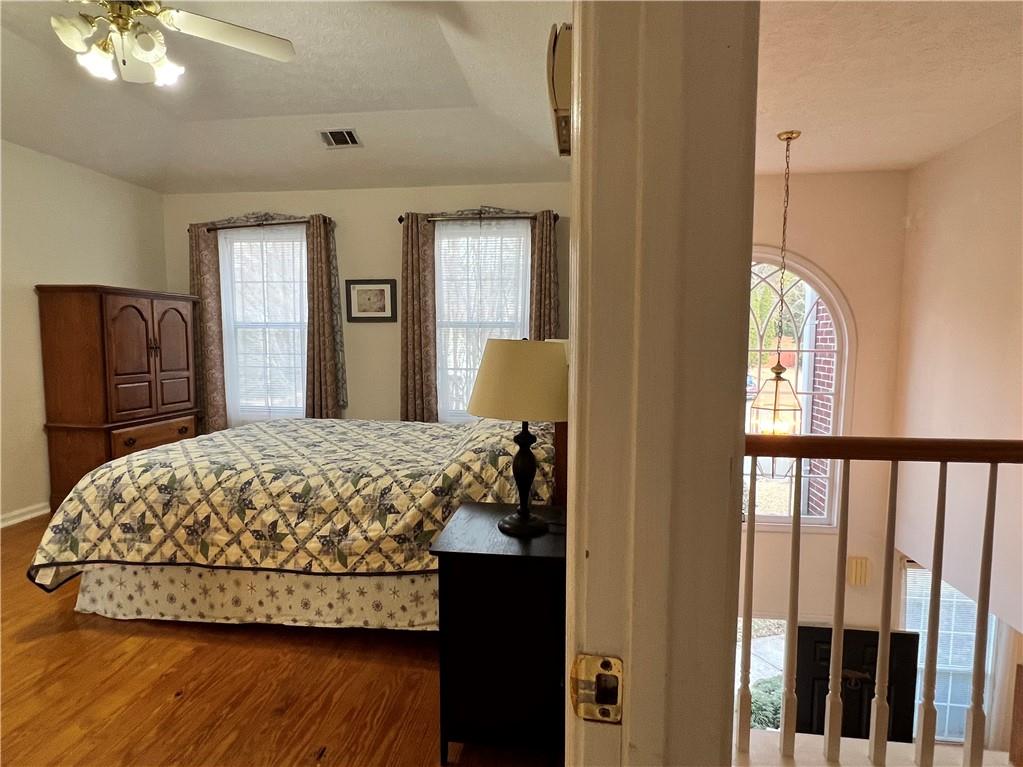 5415 Taylor Road Alpharetta, GA 30022 - Photo 17 of 29 a bedroom with a bed and a dresser