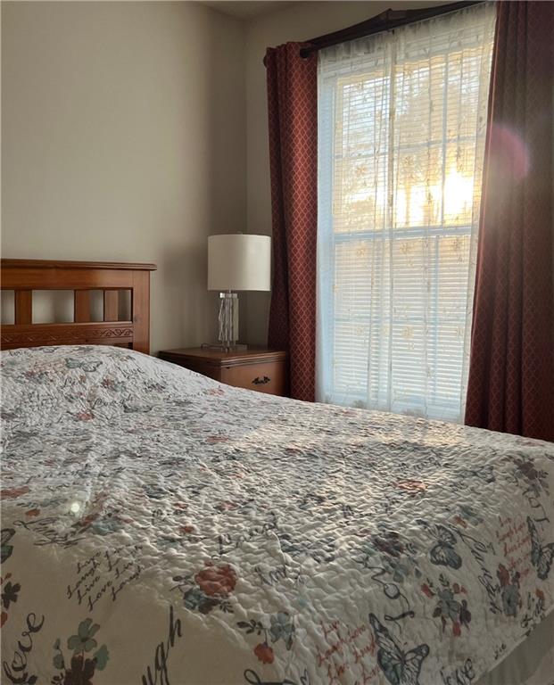 5415 Taylor Road Alpharetta, GA 30022 - Photo 18 of 29 a bedroom with a bed and a window