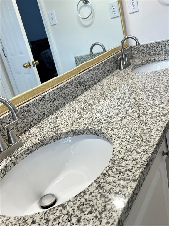 5415 Taylor Road Alpharetta, GA 30022 - Photo 19 of 29 a bathroom with a granite countertop sink and a mirror