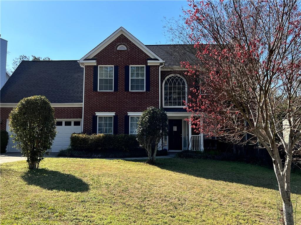 5415 Taylor Road Alpharetta, GA 30022 - Photo 3 of 29 a front view of a house with garden