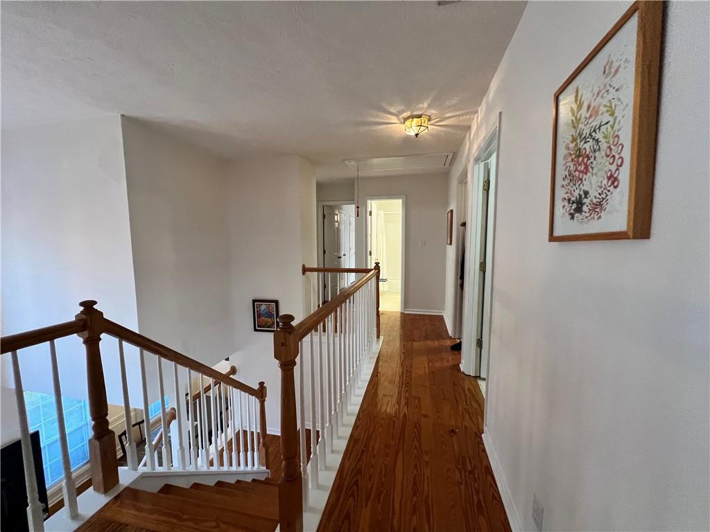 5415 Taylor Road Alpharetta, GA 30022 - Photo 6 of 29 a view of a hallway with wooden floor and staircase