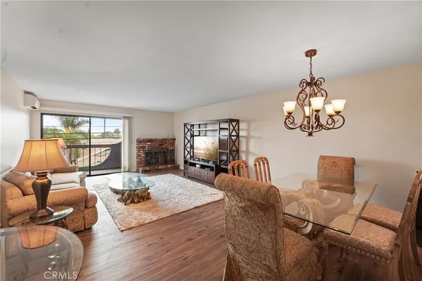 a living room with furniture chandelier and a window