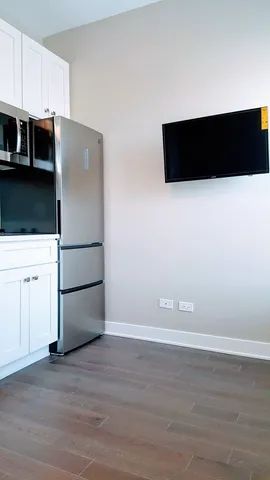 a view of a kitchen with refrigerator and microwave
