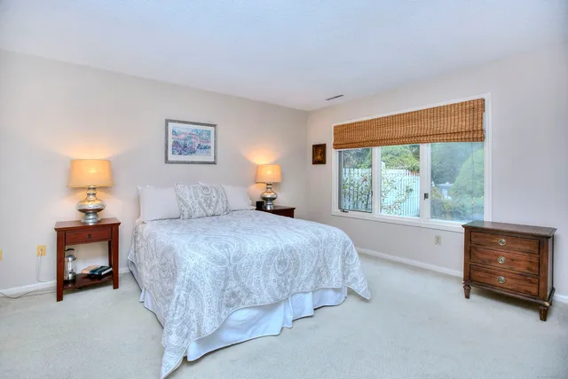 a bed room with a bed and a window