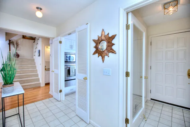 a view of an entryway with wooden floor and cabinet