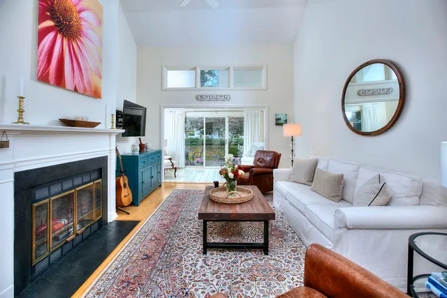 a living room with furniture a flat screen tv and a fireplace
