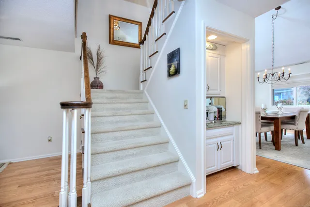 a view of entryway and hall with wooden floor